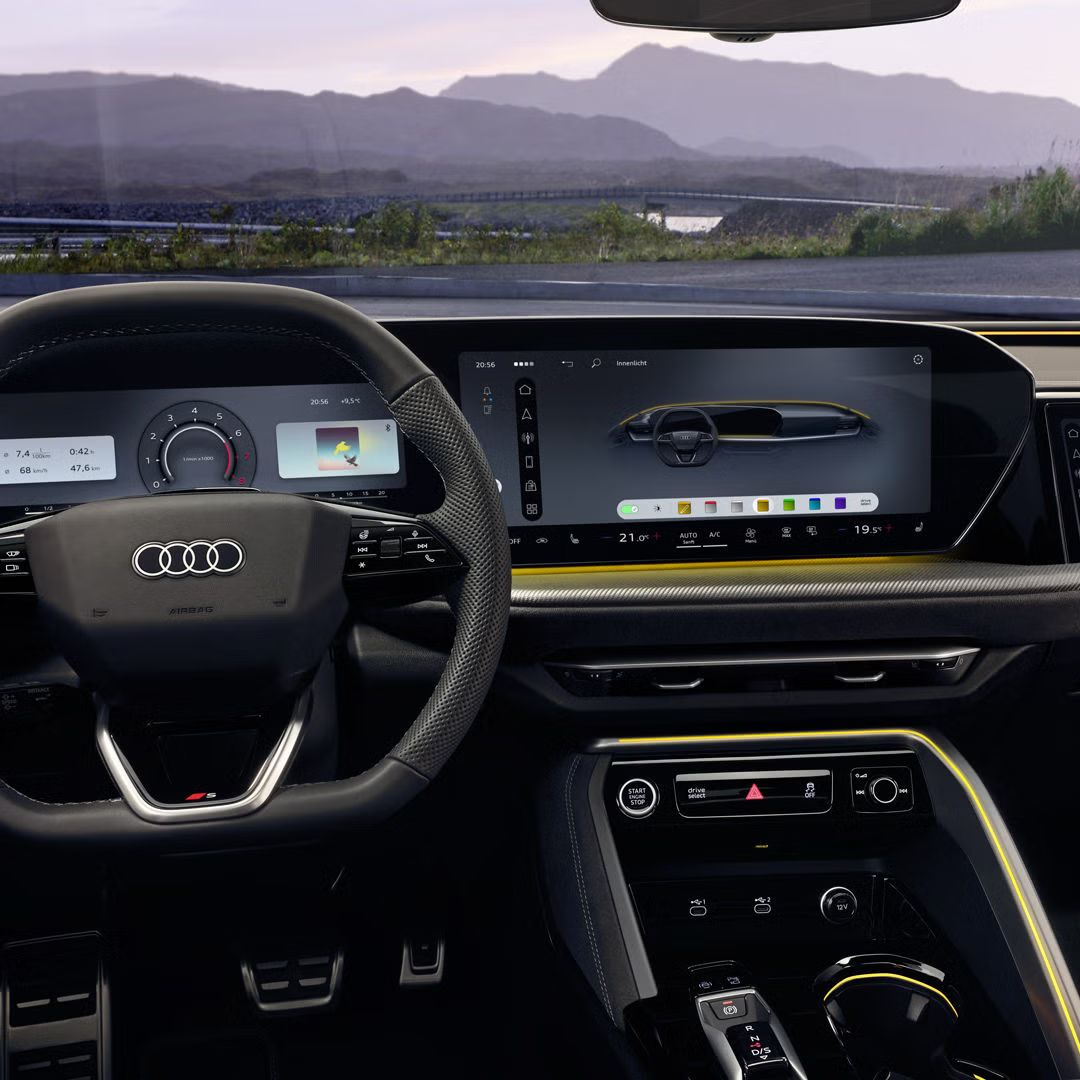 Blick auf das Cockpit des SQ5 Sportback aus der Perspektive des Fahrers. Zu sehen sind unter anderem das Lenkrad mit dem sich dahinter befindlichen Audi Virtual Cockpit, das MMI touch-Display, sowie die Ambiente Beleuchtung.