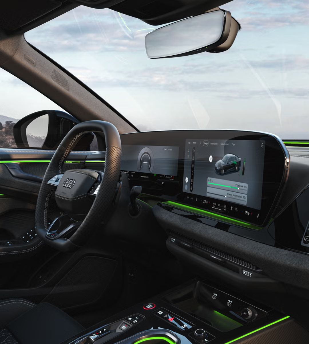 Nahaufnahme des Cockpits aus Beifahrerperspektive mit Fokus auf dem MMI-Display. Auf diesem wird der aktuelle Ladezustand sowie ein Slider zur Regelung der Reserve angezeigt.