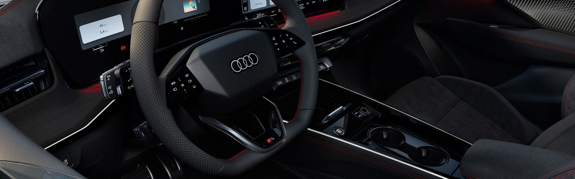 Blick von vorne auf das Lenkrad, Mittelkonsole und digitale Displays im Audi Q3 Sportback