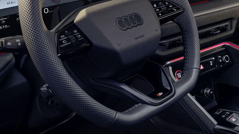 Blick in das Cockpit des SQ5 Sportback durch das Fahrerfenster. Zu sehen sind die verschiedenen Displays im Cockpit, sowie die rote Ambiente Beleuchtung.