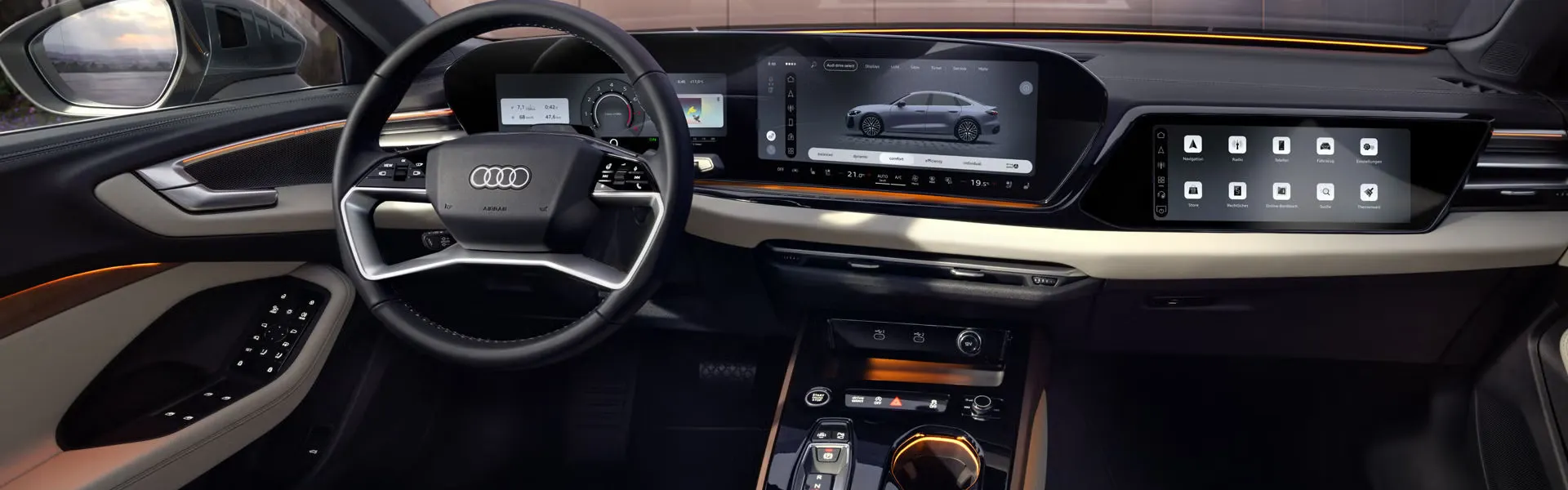 Blick von der Rückbank in das Cockpit der A5 Limousine. Zu sehen sind unter anderem die MMI Displays und das Lichtdesign mit dem Interaktionslicht am unteren Rand der Windschutzscheibe.