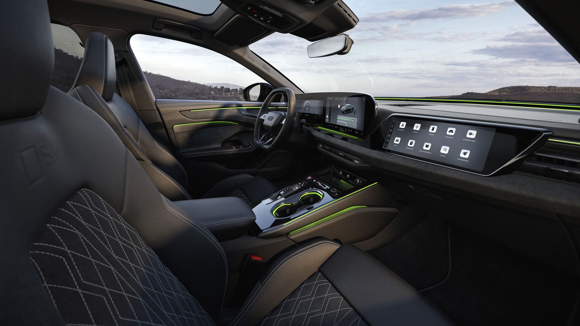 Das Cockpit der A6 Limousine e-hybrid aus Beifahrerperspektive. Der Fokus liegt dabei auf dem Lenkrad sowie den Panorama-Displays und dem grünen Ambiente-Licht.