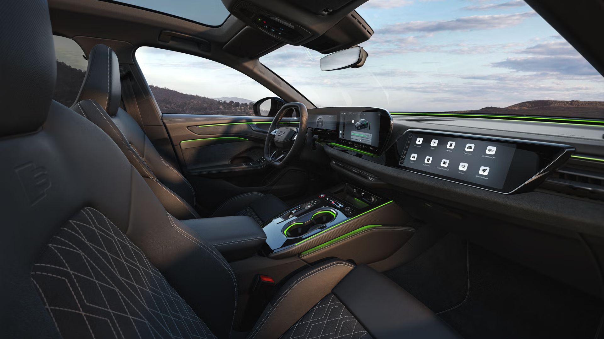 Das Cockpit der A6 Limousine e-hybrid aus Beifahrerperspektive. Der Fokus liegt dabei auf dem Lenkrad sowie den Panorama-Displays und dem grünen Ambiente-Licht.